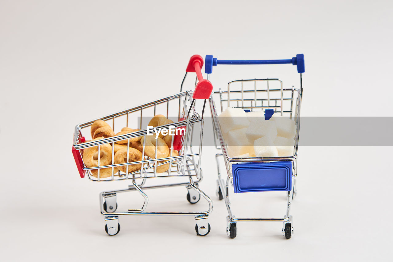 shopping cart, cart, shopping, consumerism, retail, supermarket, studio shot, store, indoors, cut out, buying, no people, push cart, business, groceries, shopping basket, white background, finance