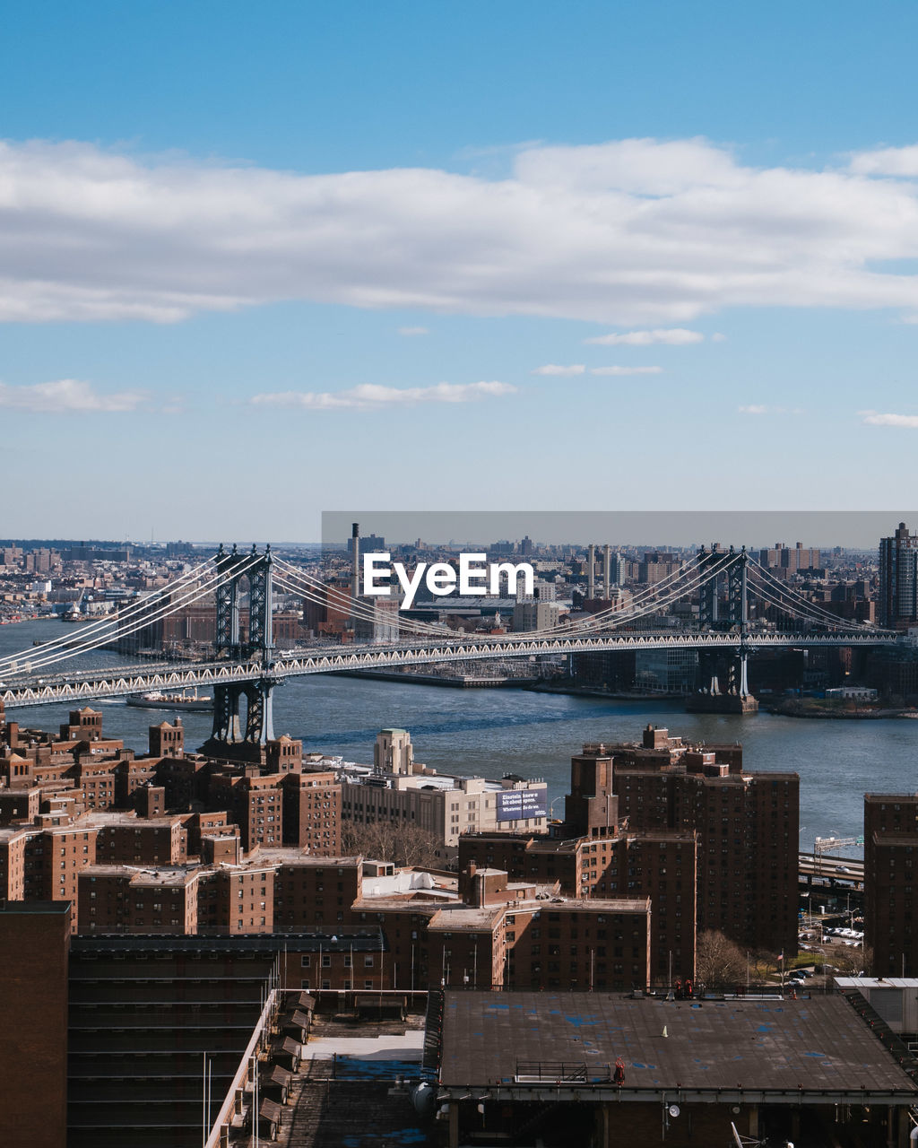 Aerial view of city against cloudy sky