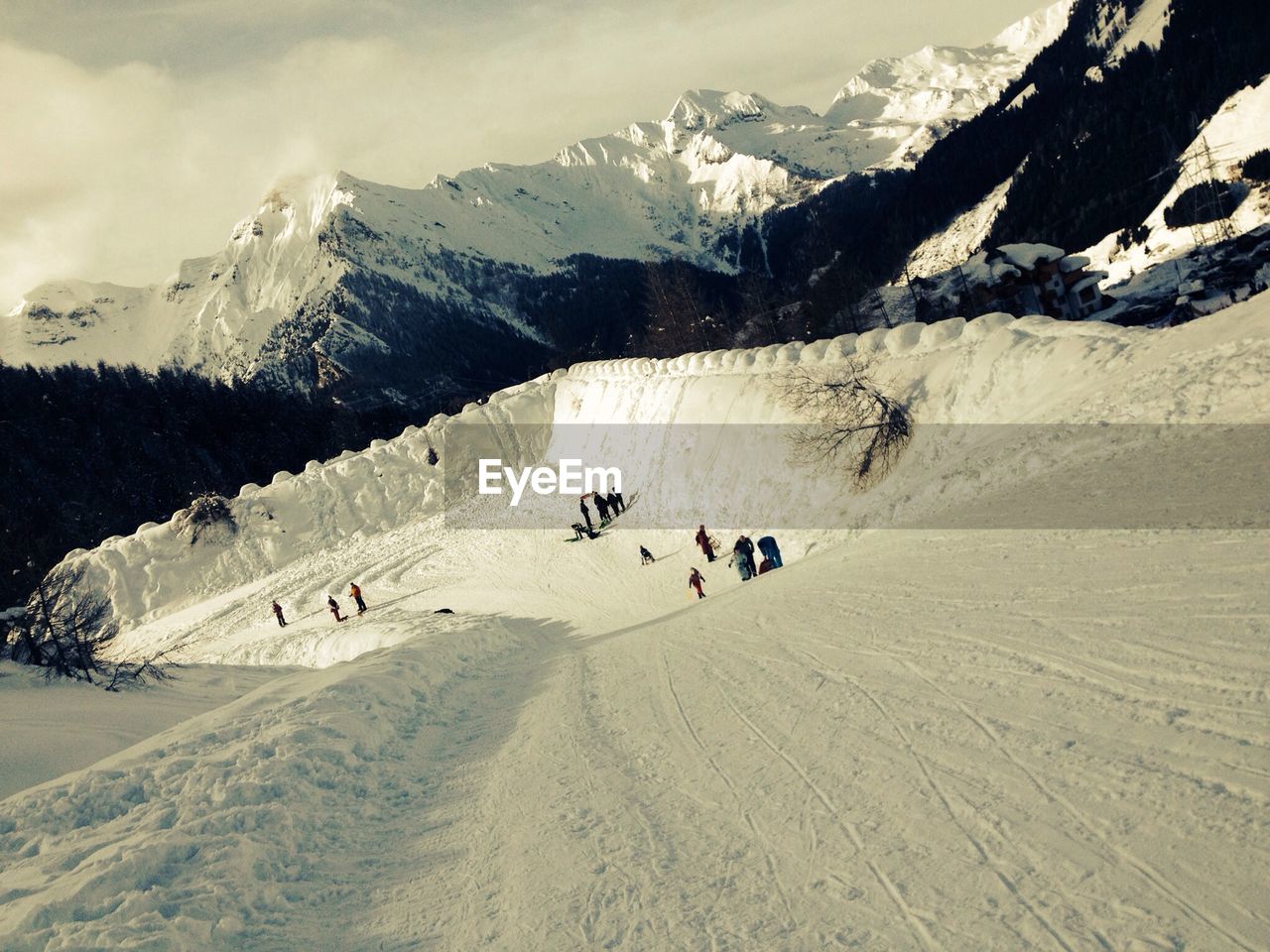 TOURISTS ON SNOW COVERED MOUNTAINS