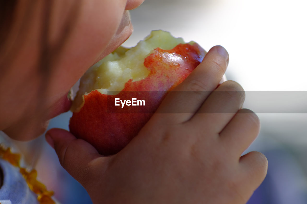 Close-up of girl eating fruit