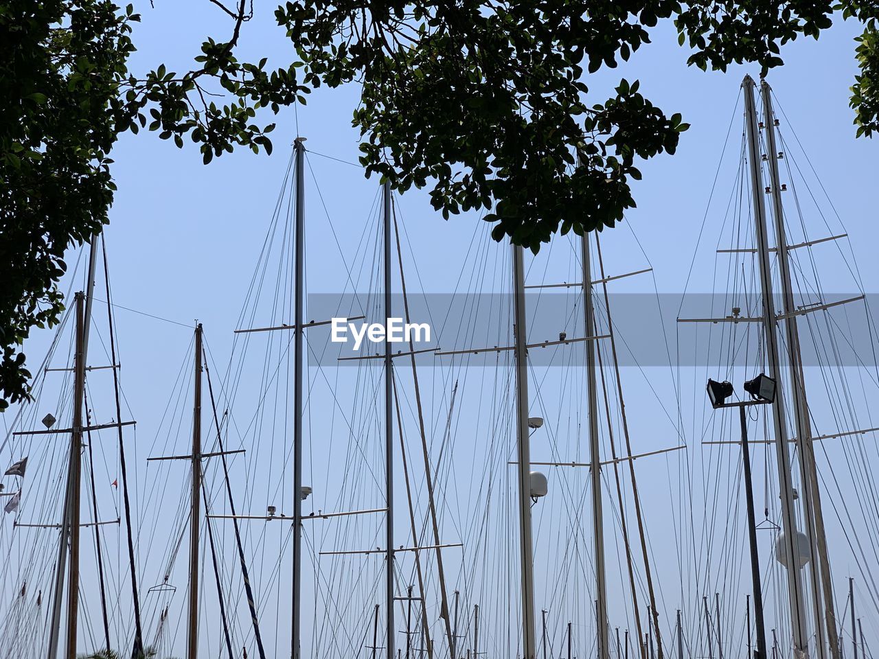 LOW ANGLE VIEW OF SAILBOAT AGAINST SKY AT DUSK