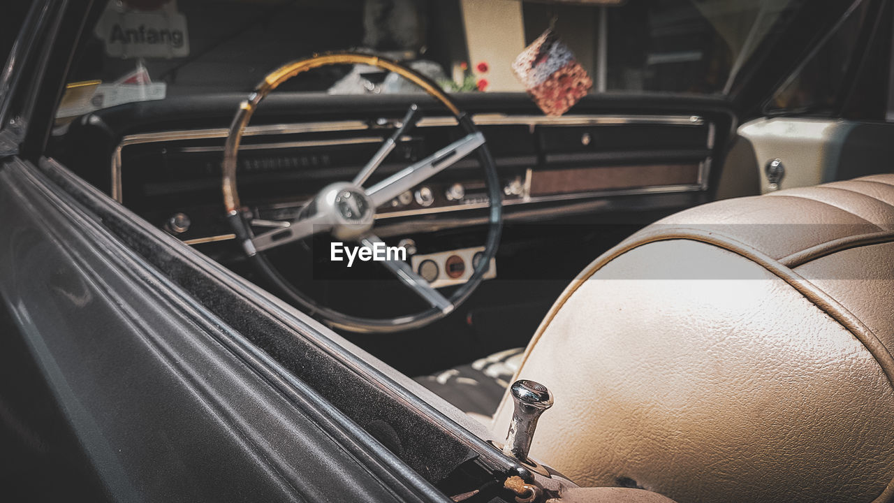 car, vehicle, transportation, mode of transportation, land vehicle, motor vehicle, automobile, indoors, luxury vehicle, clothing, no people, steering wheel, vintage car, wheel, retro styled
