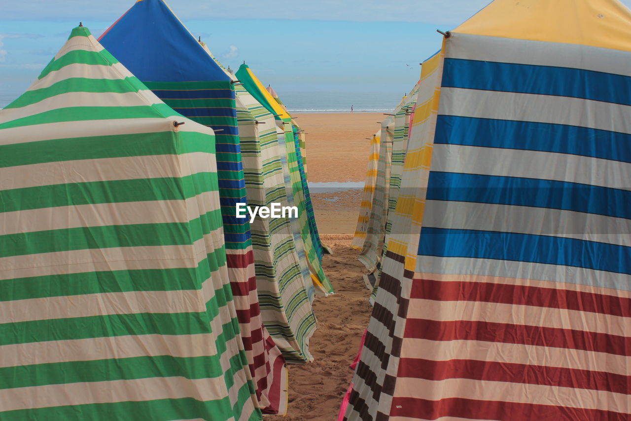 Low angle view of multi colored umbrellas against sky