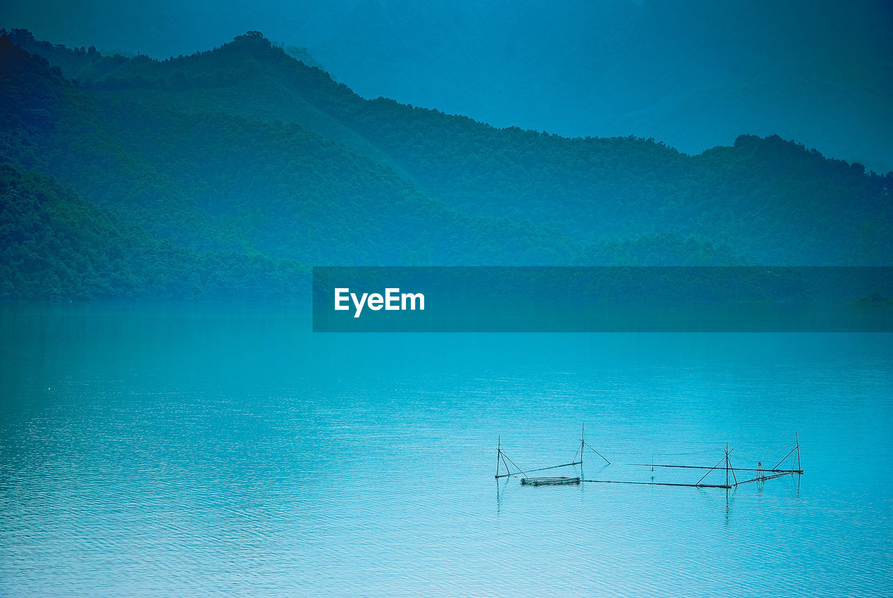 Scenic view of lake against blue sky