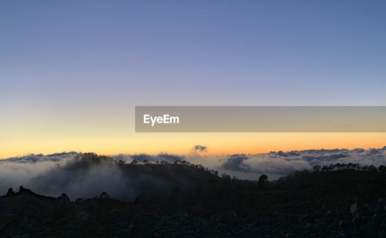 Scenic view of landscape against sky during sunset