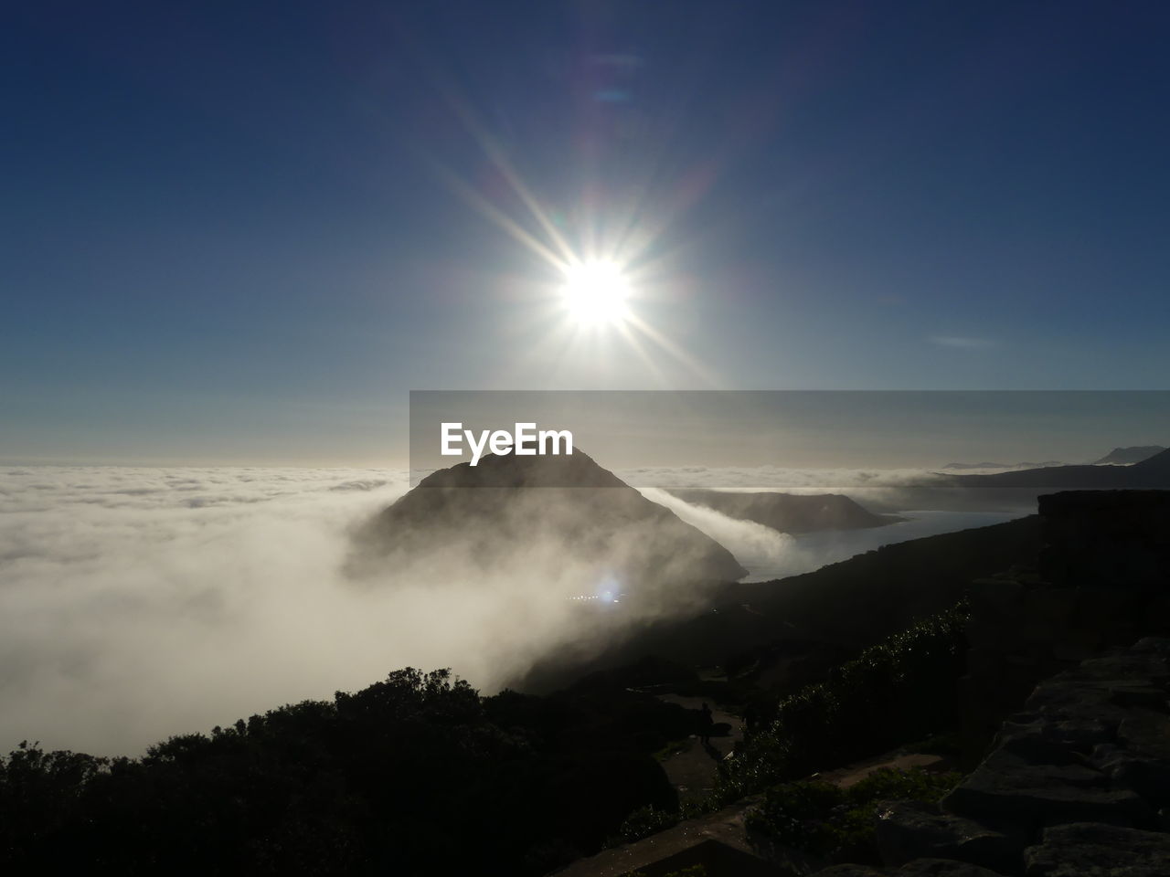Scenic view of silhouette mountains against sky on sunny day
