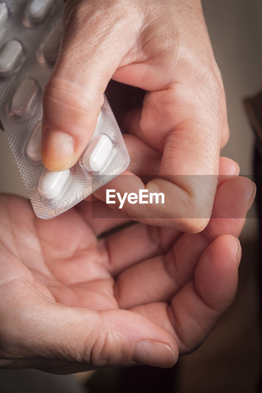 CLOSE-UP OF HANDS HOLDING BABY