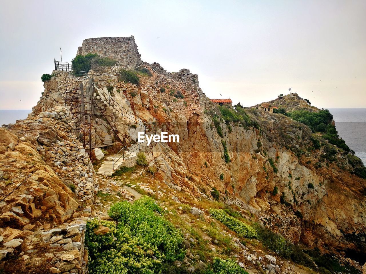 Rock formations by sea against sky