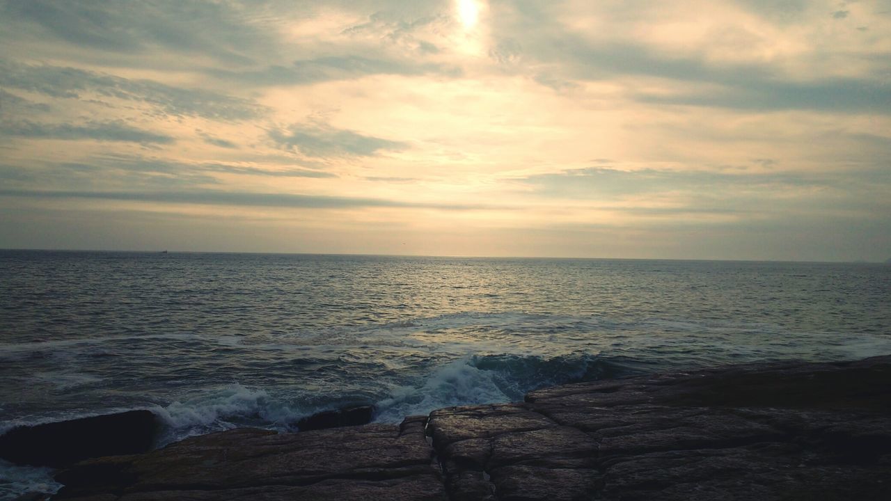 SCENIC VIEW OF BEACH AGAINST SKY DURING SUNSET