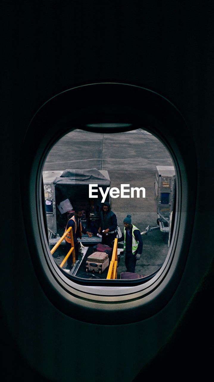 REFLECTION OF PEOPLE ON SIDE-VIEW MIRROR IN CAR