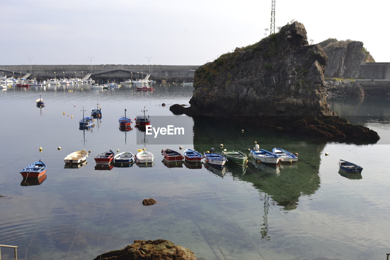 Boats moored on sea against sky