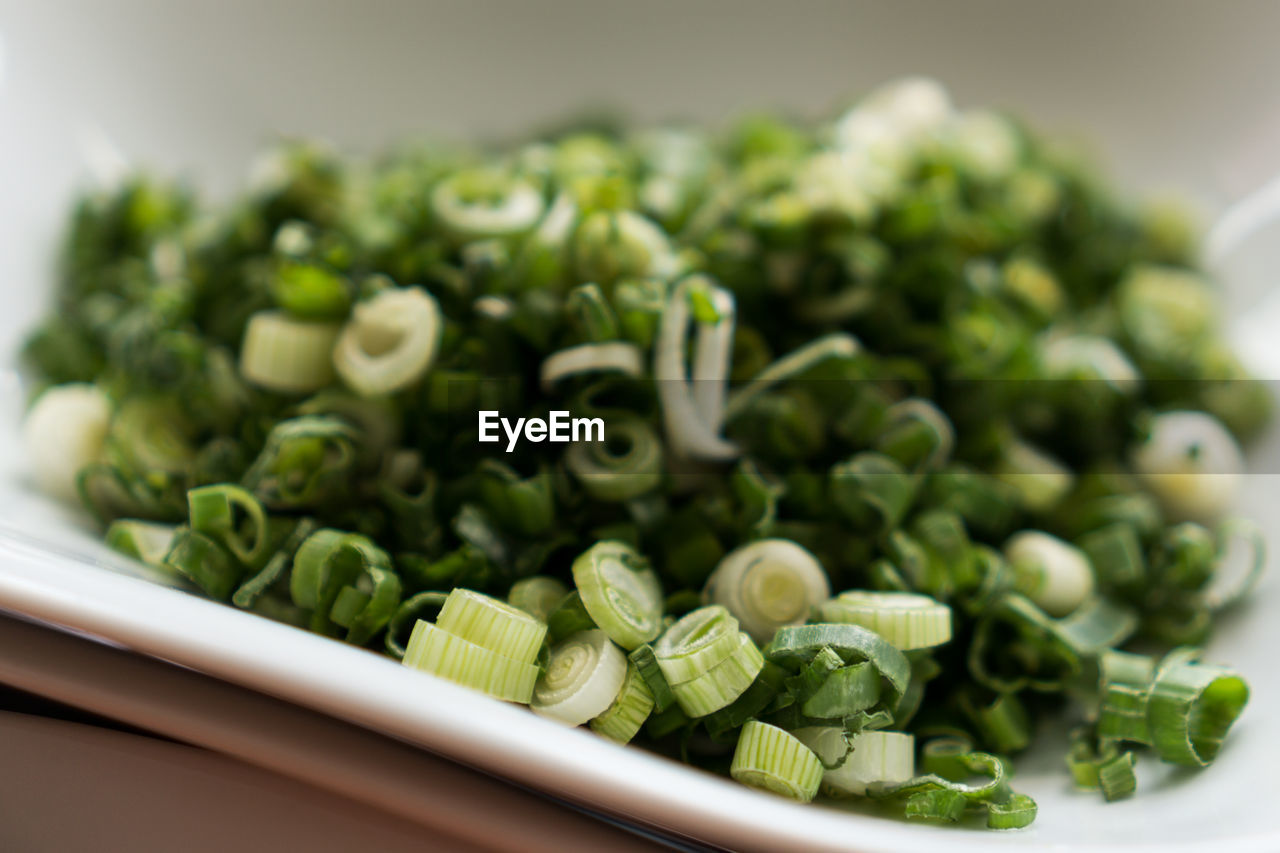 Close-up of chopped spring onions in plate