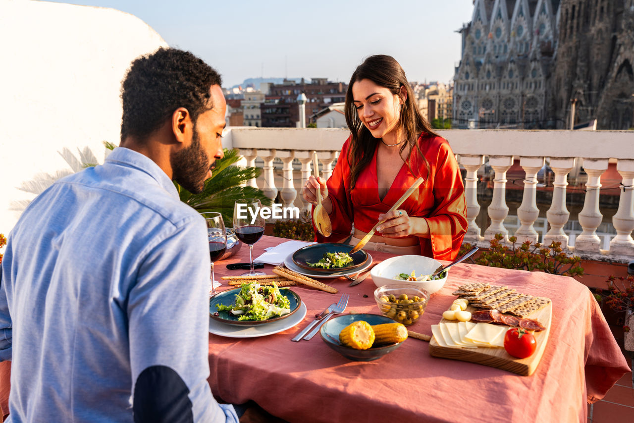 portrait of smiling friends having food at restaurant