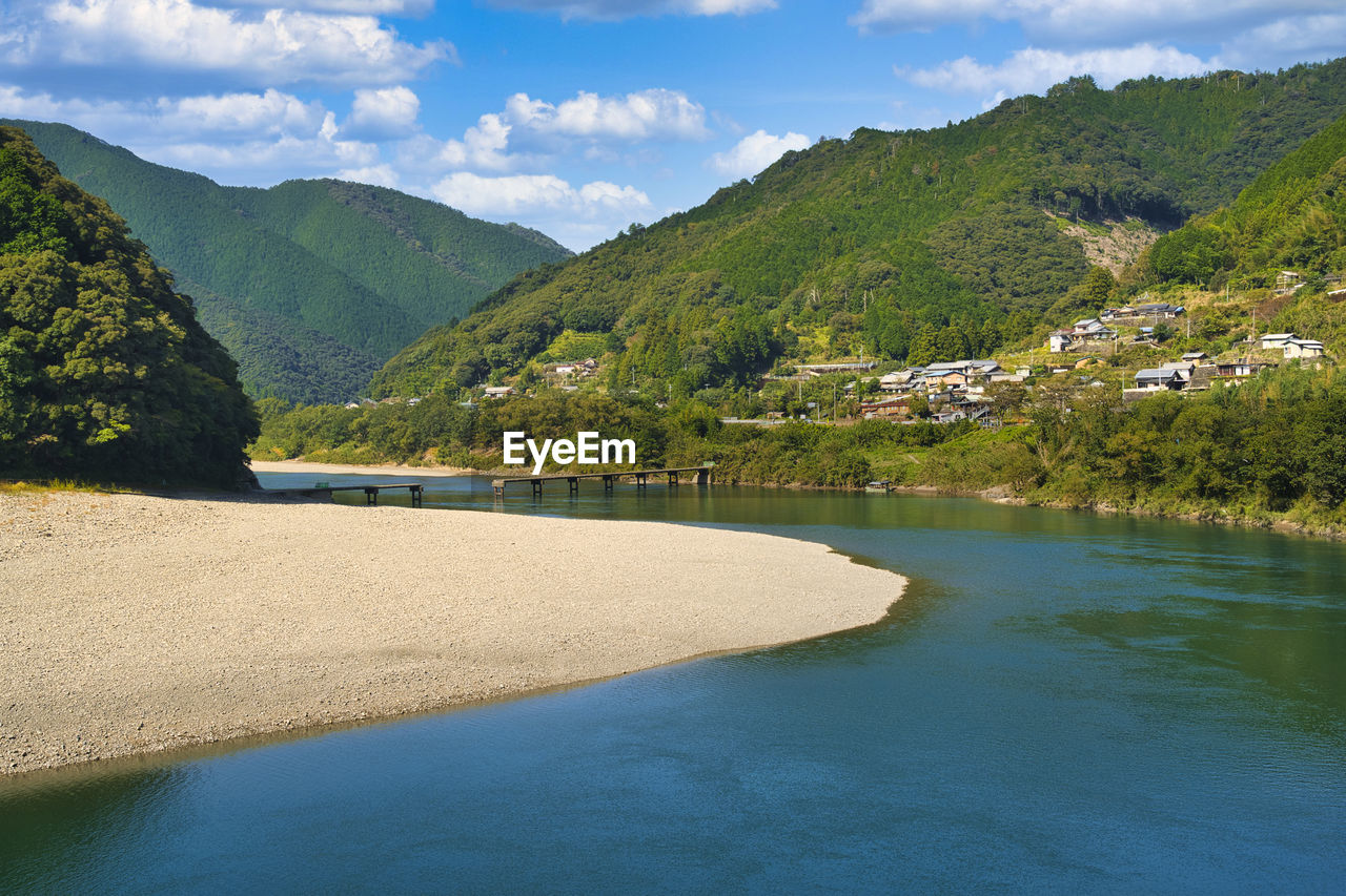 Scenic view of shimanto river by mountains 