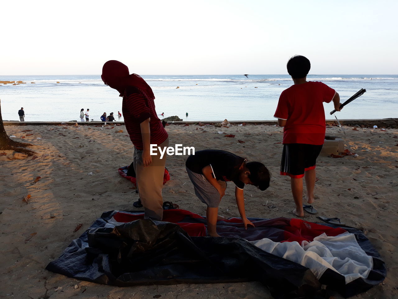 PEOPLE PLAYING ON BEACH