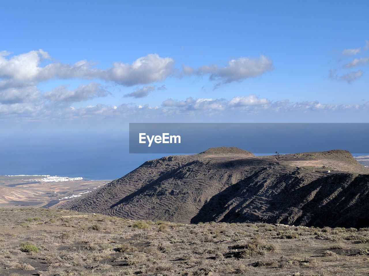 Scenic view of rock formations against blue sky