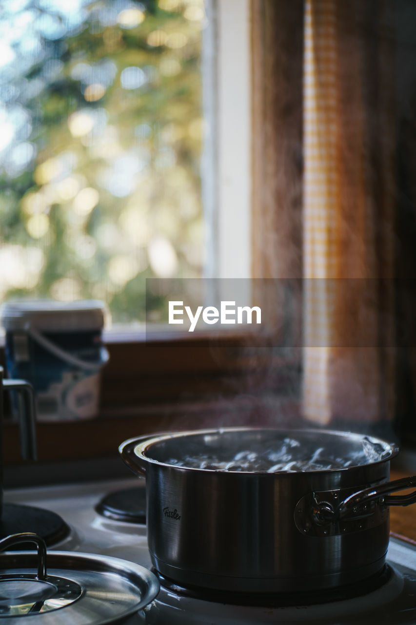 Close-up of potatoes boiling in saucepan on stove