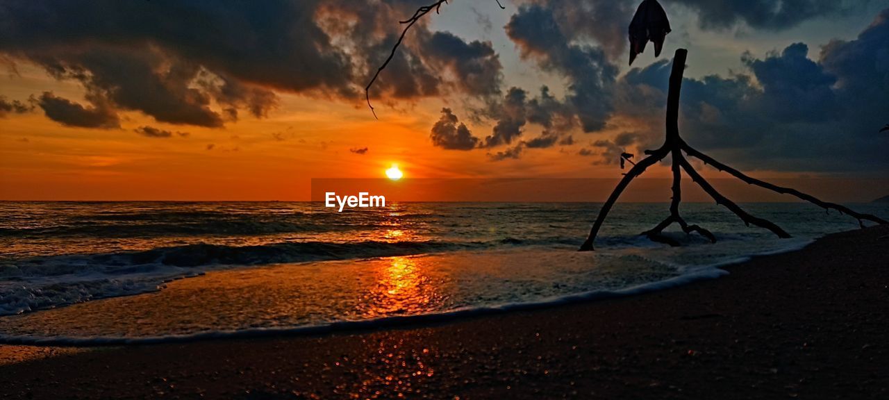 sky, sea, water, sunset, beach, land, beauty in nature, horizon, cloud, nature, scenics - nature, ocean, horizon over water, tranquility, evening, tranquil scene, sun, wave, dusk, orange color, sunlight, sand, shore, coast, idyllic, silhouette, outdoors, dramatic sky, travel destinations, afterglow, reflection, no people, seascape, panoramic, environment, coastline, landscape, tropical climate