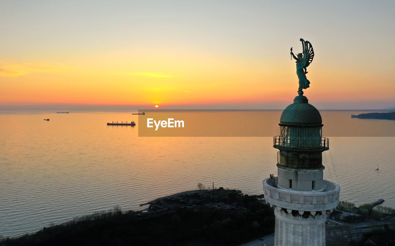 STATUE IN SEA DURING SUNSET