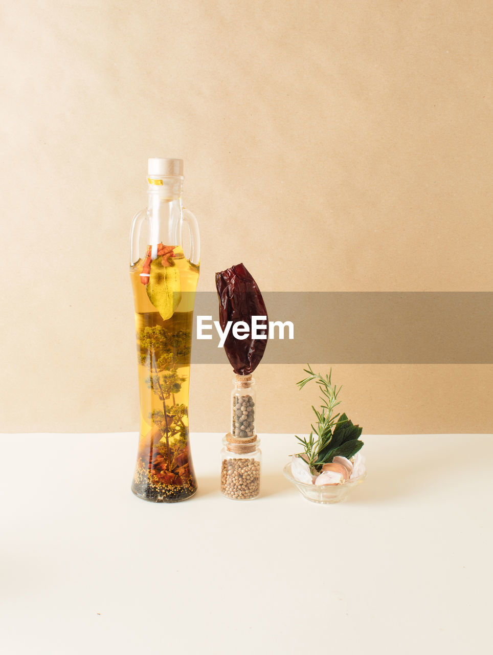 Bottle with olive oil and spices. infographic food style. close up. cooking concept.