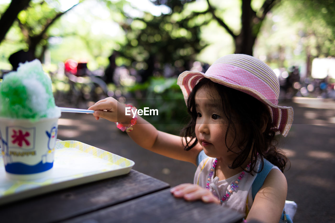 Close-up of girl eating ice cream on table
