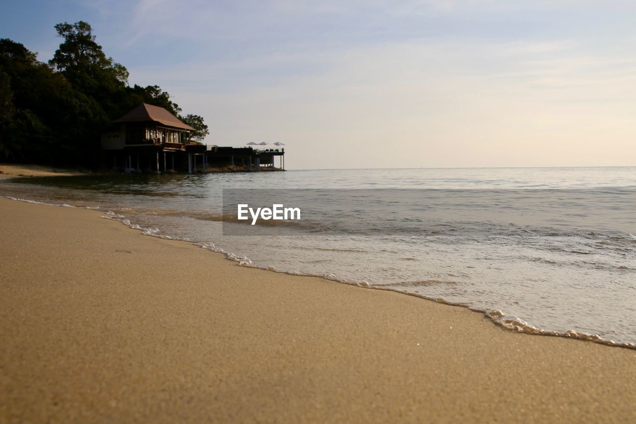 Scenic view of beach against sky during sunset