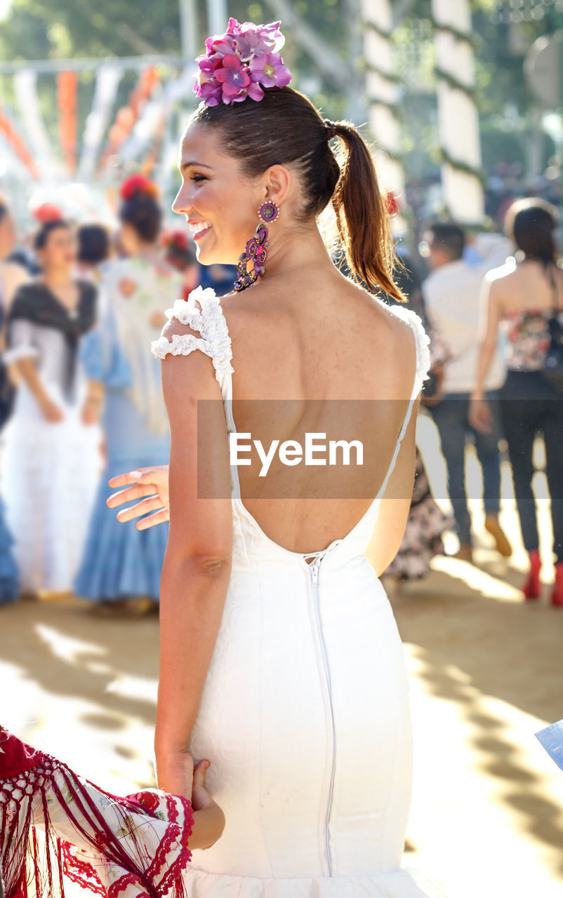 MIDSECTION OF WOMAN WITH HANDS HOLDING UMBRELLA