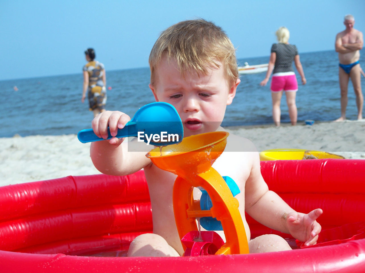 Boy playing with toy on beach