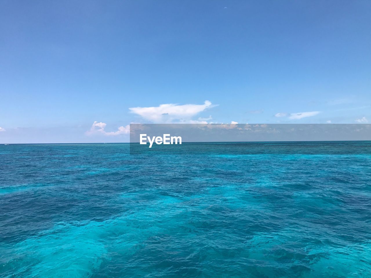 Scenic view of sea against blue sky