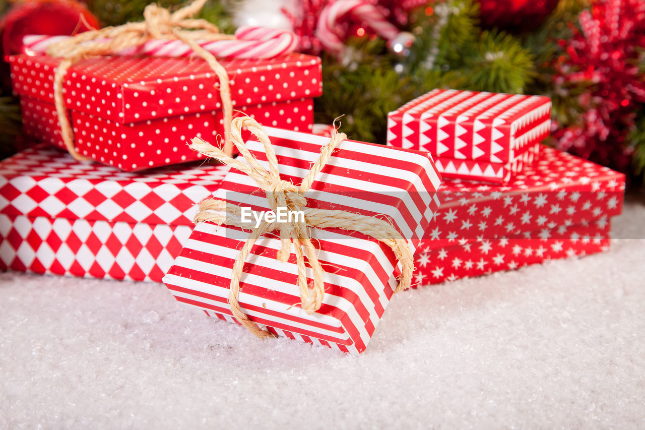 Close-up of christmas presents on artificial snow
