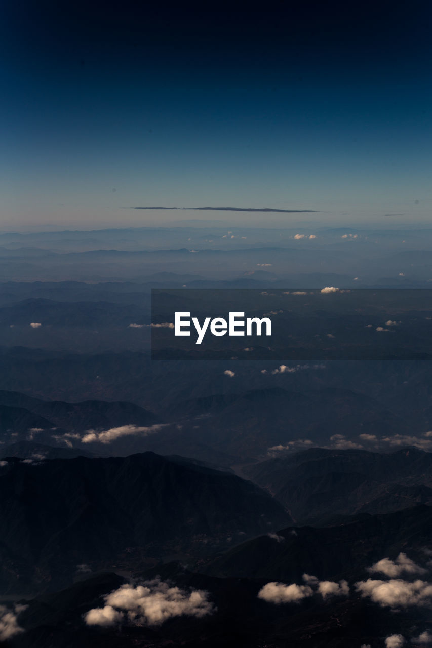 Scenic view of landscape seen through airplane window