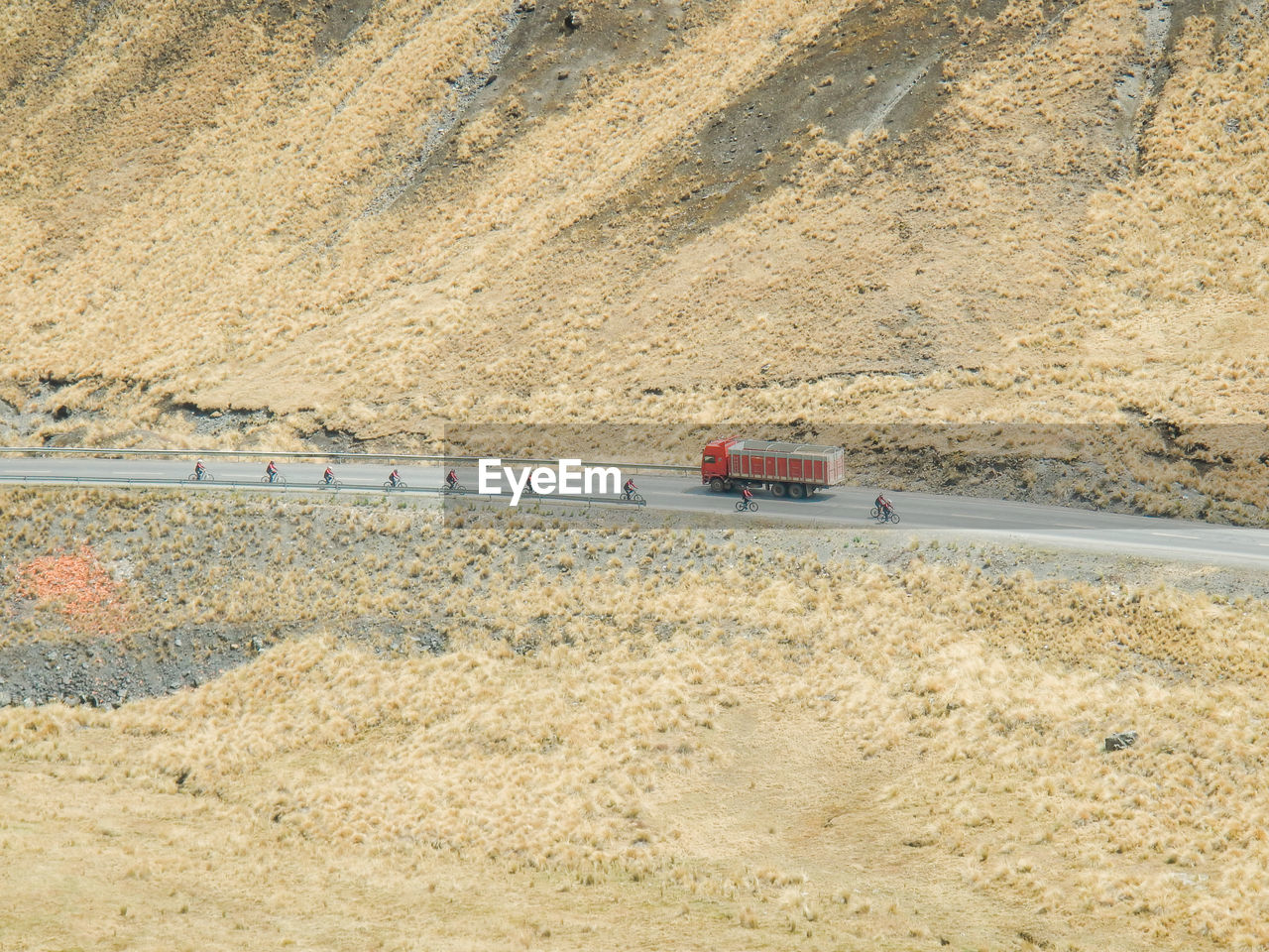 HIGH ANGLE VIEW OF VEHICLES ON ROAD AGAINST THE SKY