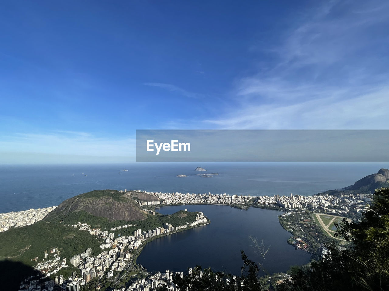 HIGH ANGLE VIEW OF SEA AND CITY AGAINST SKY