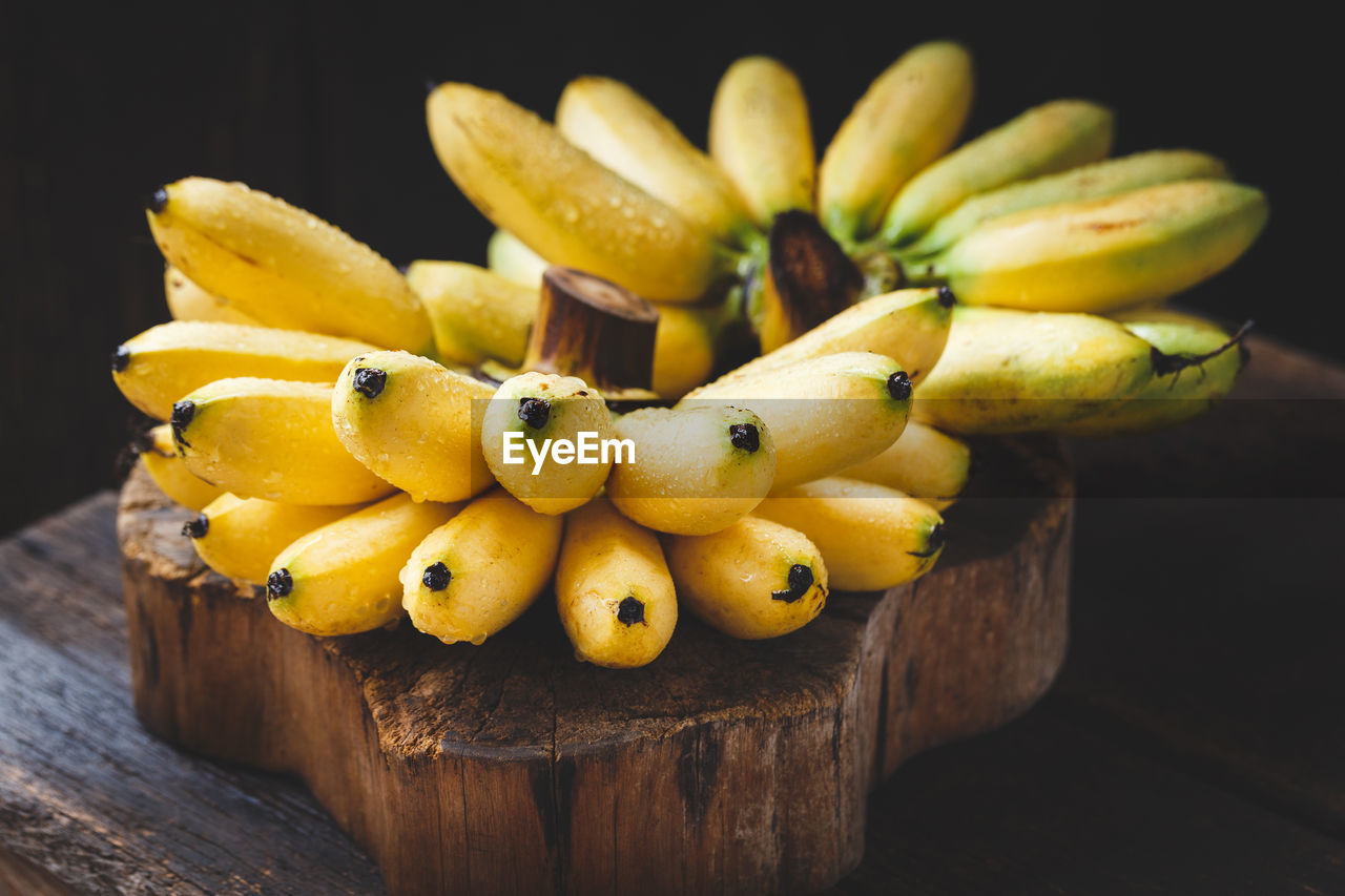Close-up of wet bananas on wooden table