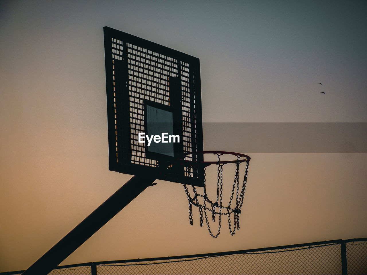 basketball, basketball hoop, light, lighting, sky, sports, low angle view, net - sports equipment, no people, line, architecture, sunset, nature, basketball - ball, outdoors, blue