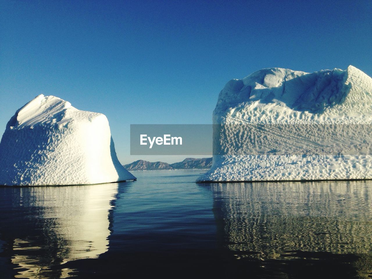 Ice berg in sea against clear sky