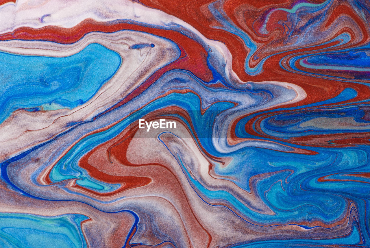 Abstract liquid art painting. pattern with abstract red, blue and white waves. liquid paint. 