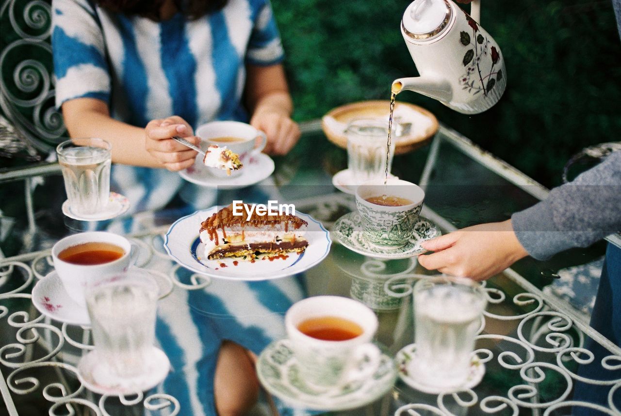 People having food and drink at table