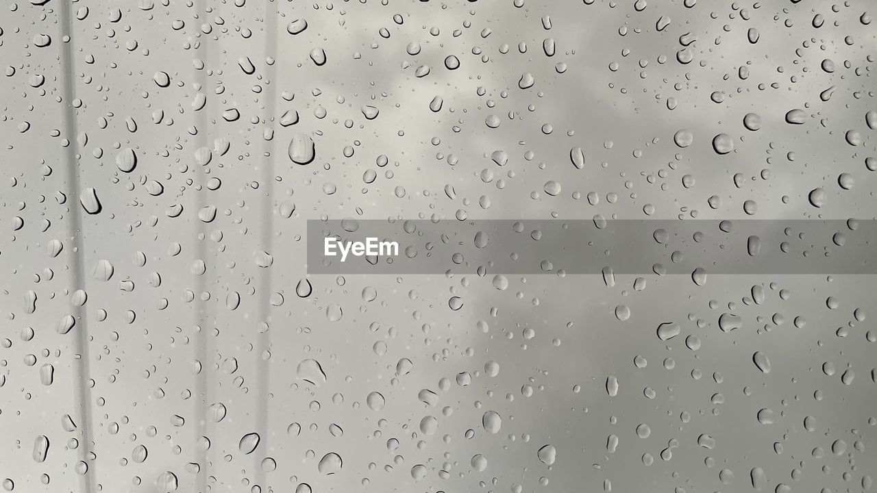 full frame shot of raindrops on glass