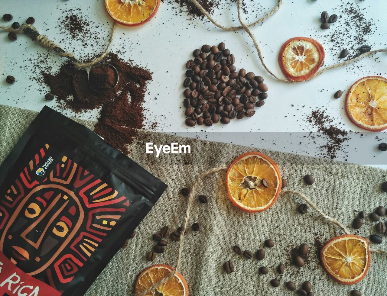 HIGH ANGLE VIEW OF COFFEE AND CUPS ON TABLE AT HOME