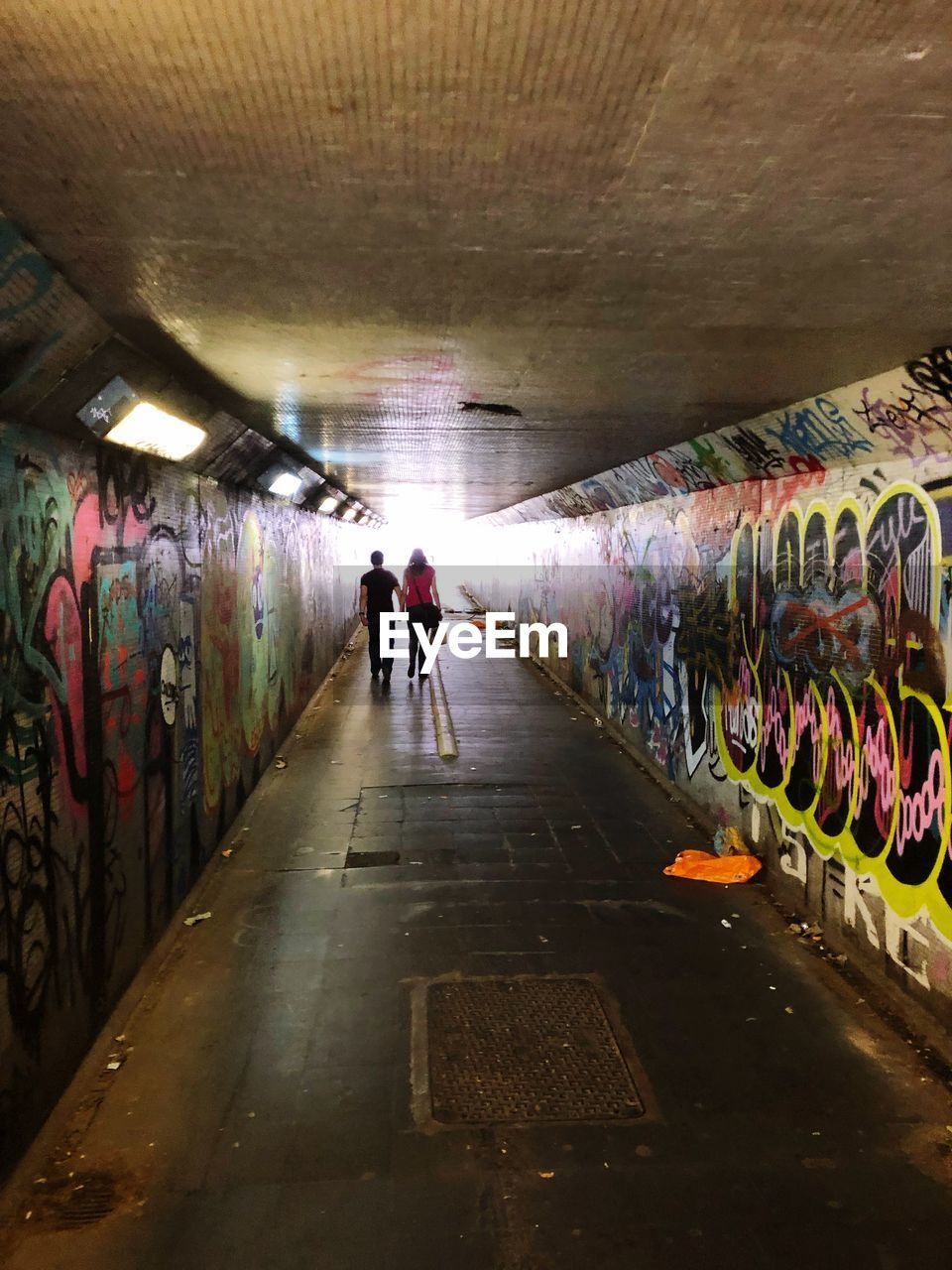 PEOPLE WALKING IN TUNNEL