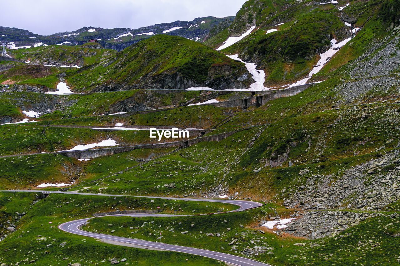 Mountain Scenics - Nature Beauty In Nature Plant Nature No People Day Tranquility Green Color Tranquil Scene Road Mountain Range Transportation Environment Grass Sky High Angle View Non-urban Scene Growth Water Outdoors View From Your Car