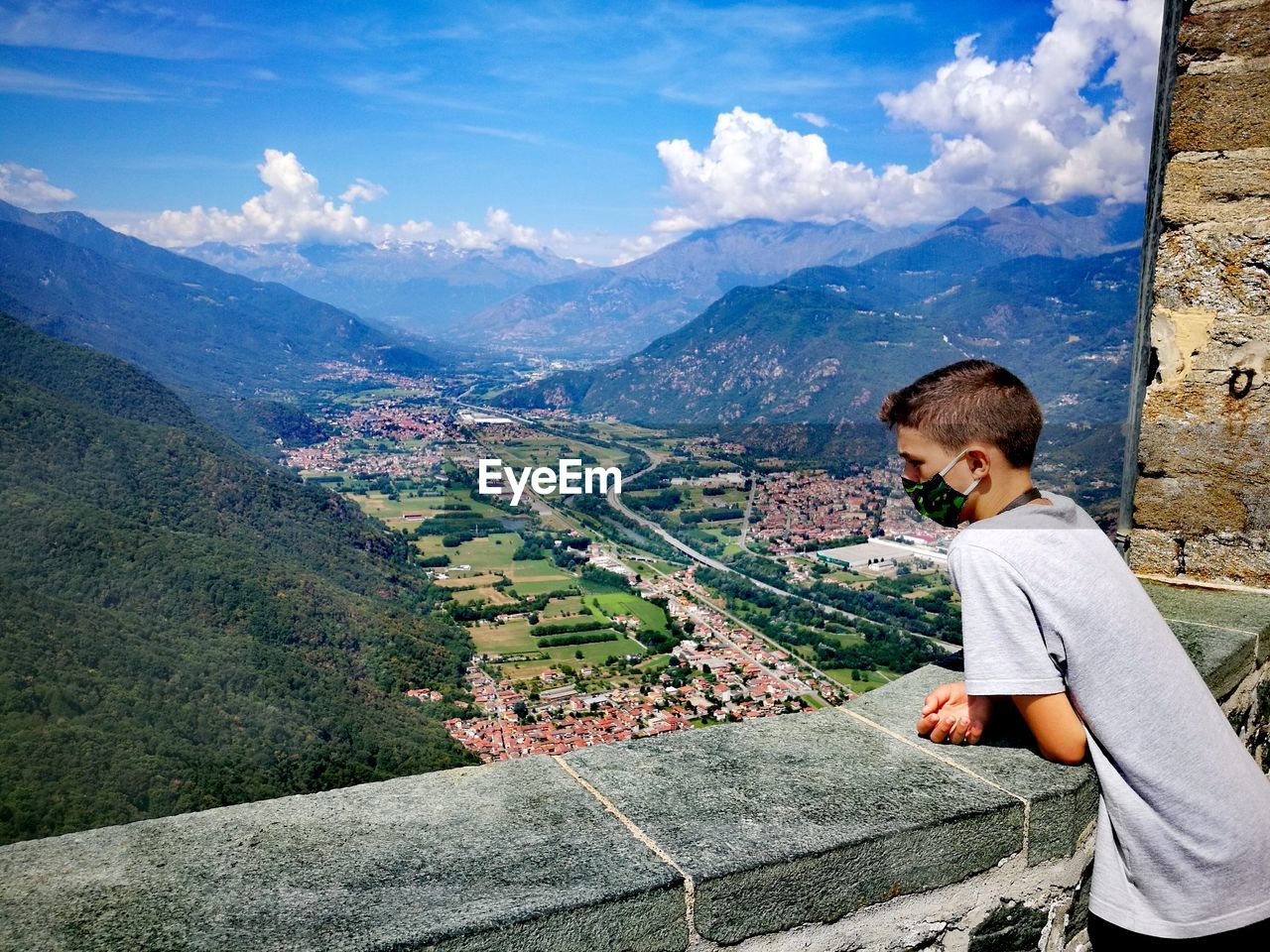 Side view of man on mountain against sky