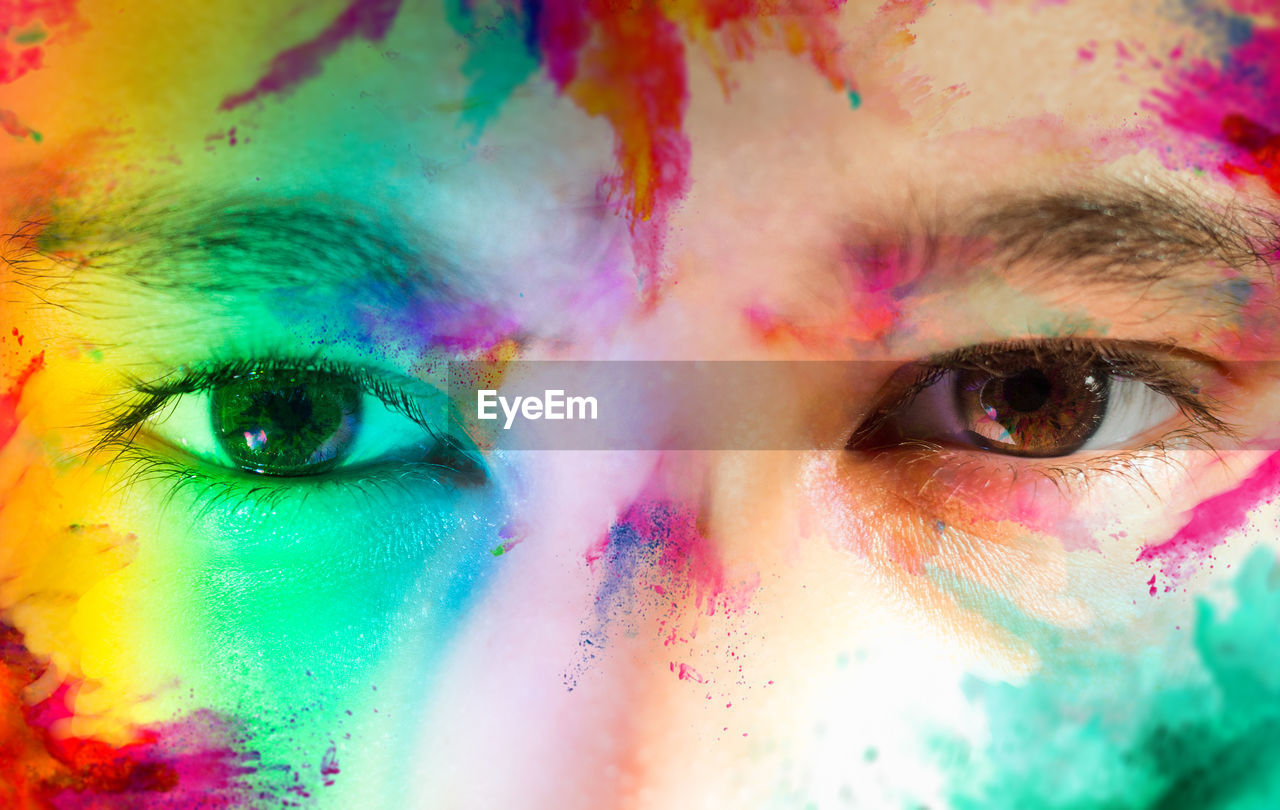 Close-up of human face with multi colored face powder