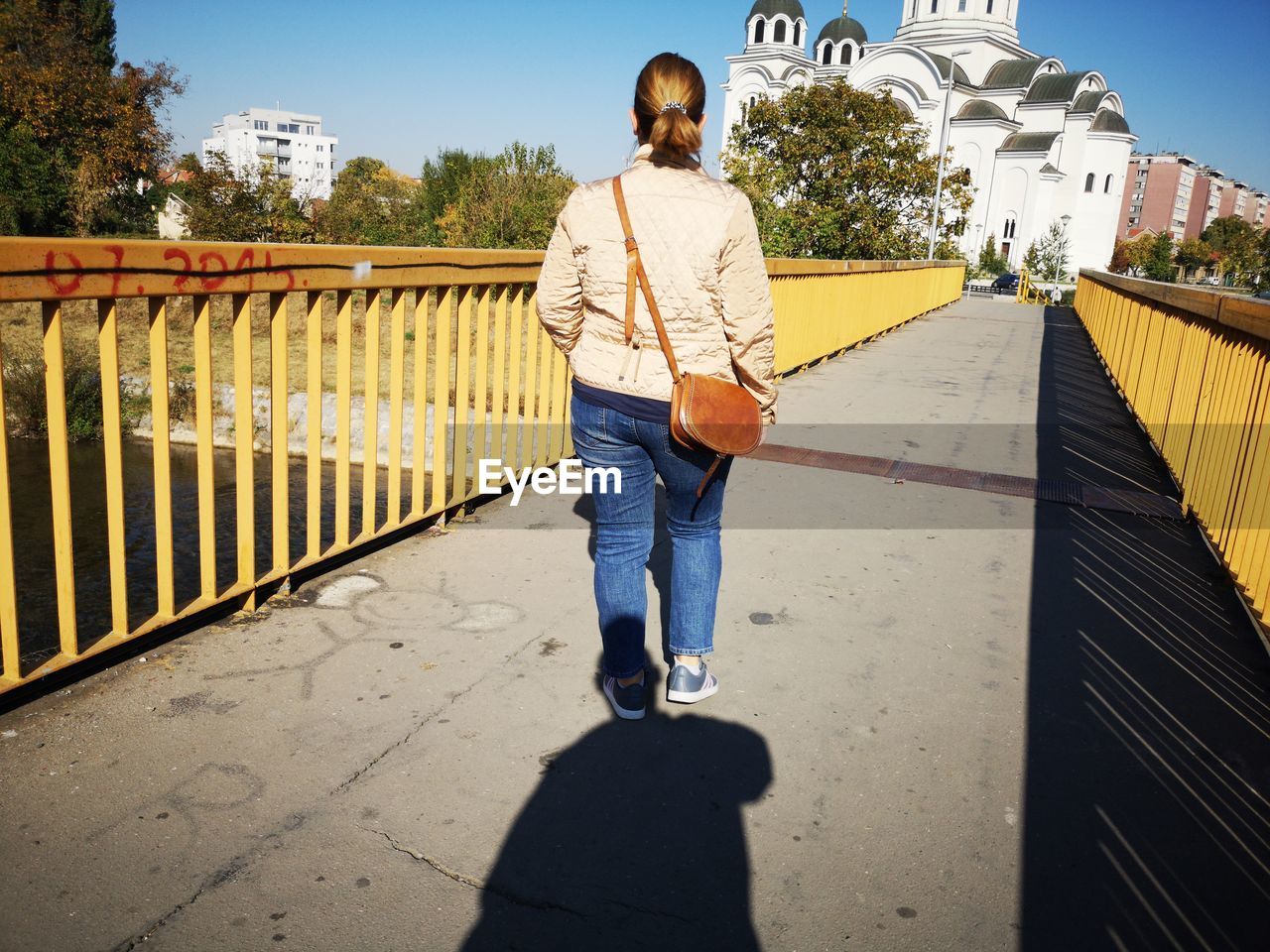 Rear view of man walking on footpath