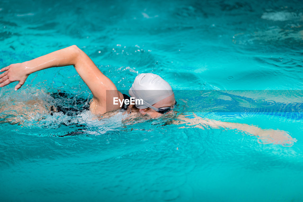 Woman swimming in pool during competition
