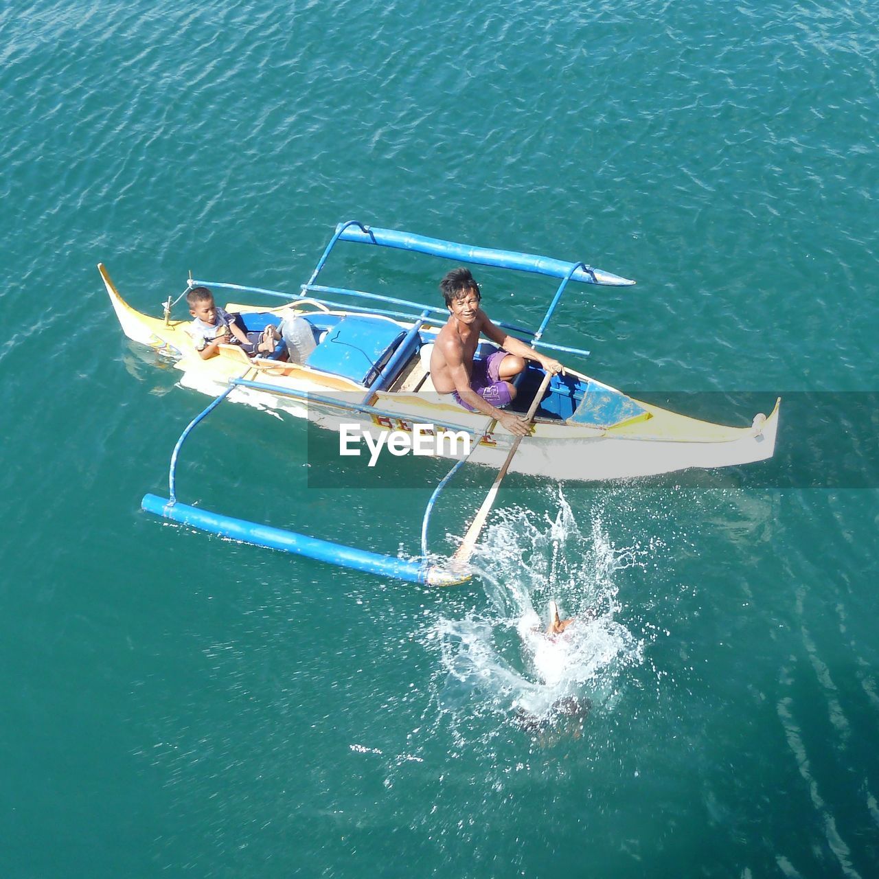 High angle view of man and boy in boat