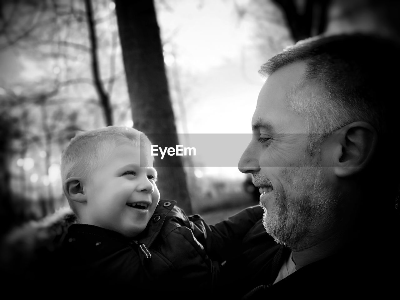 Close-up of smiling grandfather and grandchild 