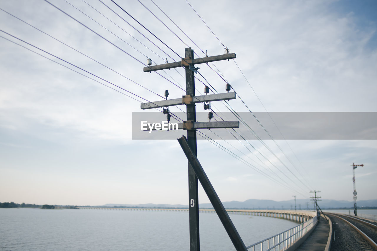 Low angle view of telephone pole against sky