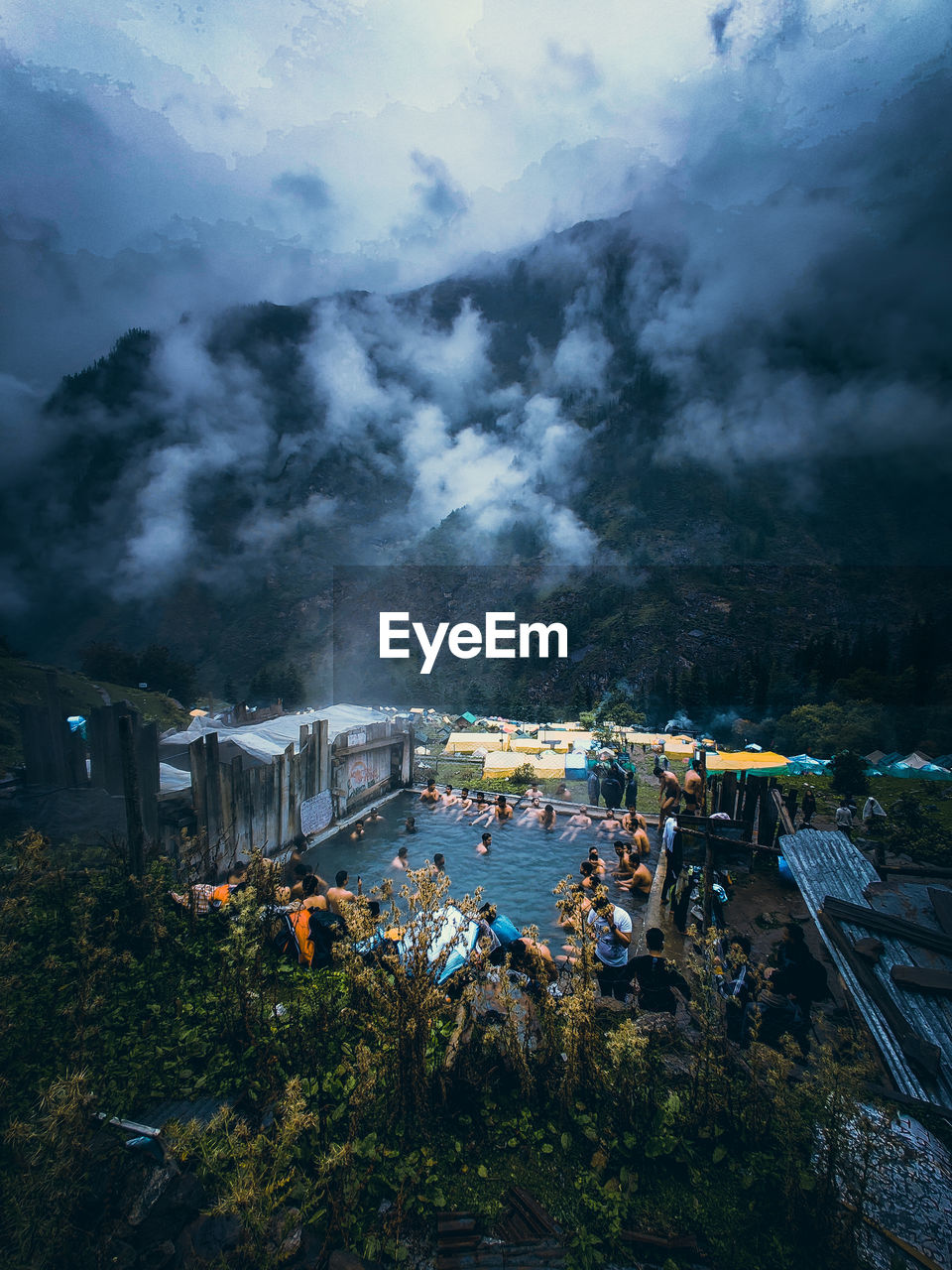 People enjoying natural hot water spring in kheerganga, kasol, himachal pradesh, india